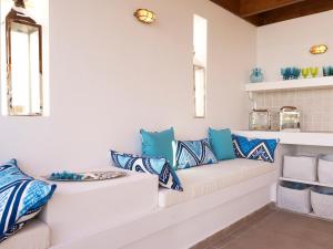 a room with blue and white pillows on a couch at Luxury Villa Eos in vlicha