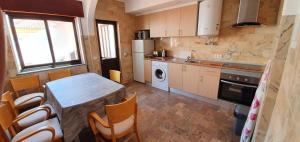 a kitchen with a table and a table and chairs at Keep Calm Apartments in Ferragudo