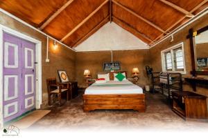 a bedroom with a bed and a purple door at Green Leaves Garden - Pinnawala in Pinnawala