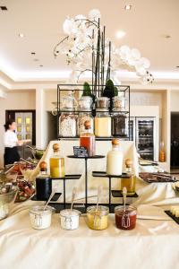 a shelf filled with jars and spoons on a table at Monte Casa SPA & Wellness in Petrovac na Moru