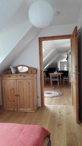 a bedroom with an open door to a living room at Zentrumsnahe Dachwohnung in grüner Oase in Lauf an der Pegnitz