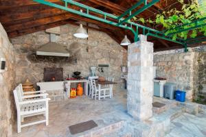 an outdoor kitchen in a stone building with a stove at Villa Casa Nostra - Kotor in Kotor