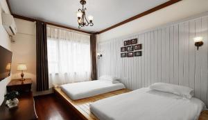 Postel nebo postele na pokoji v ubytování Memory Inn Guilin Central