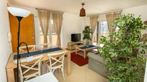 a living room with a table and some plants at Penthouse Cabanas Garden WPCG 25 by West Palm Keys in Cabanas de Tavira