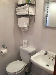 a bathroom with a white toilet and a sink at Kingscliff in Blackpool