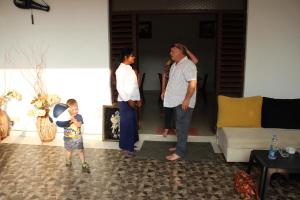 a man and a woman and a child in a living room at Miheen Hotel & Resort - Anuradhapura in Mihintale
