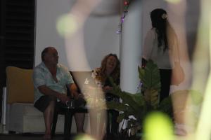 a woman sitting on a couch next to a woman standing at Miheen Hotel & Resort - Anuradhapura in Mihintale