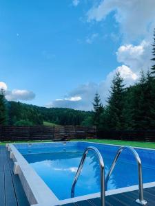a swimming pool with a view of the mountains at Hotel Superski in Cavnic