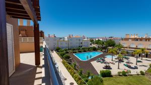 a view of the pool from the balcony of a apartment at Penthouse Cabanas Garden WPCG 25 by West Palm Keys in Cabanas de Tavira