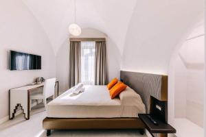 a bedroom with a white bed and white walls at Maera B&B Ravello in Ravello
