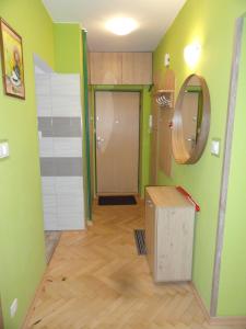 a room with green walls and a door and a box at Nocleg w Łodzi - Flatta in Łódź