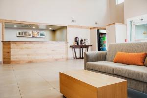 a living room with a couch and a coffee table at Country Inn & Suites by Radisson, Milwaukee West Brookfield , WI in Brookfield