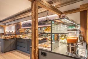 a buffet line at a restaurant with food at Hotel Sonnenspitz *** in Kochel
