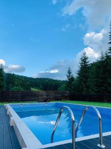 a swimming pool with a view of the mountains at Mountain Apartments SuperSki in Cavnic
