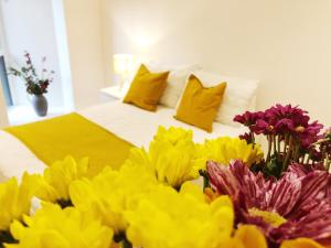 a bed with a bunch of yellow and purple flowers at Ekhaya three in Manchester