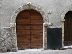 una porta di legno sul lato di un edificio di Appartamento Riva Del Garda a Riva del Garda