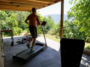 a man walking on a treadmill in a gym at Le Ginestre Apartments Assisi in Assisi