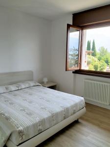 Tempat tidur dalam kamar di Appartamenti Garda il lago