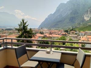 a balcony with two chairs and a table with a view at Appartamenti Garda il lago in Riva del Garda