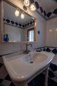 a bathroom with a sink and a mirror at Villa Eirini with sea view in Dhriópi