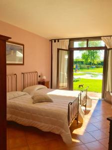 a bedroom with two beds and a large window at Motel Cosmera in Savigliano