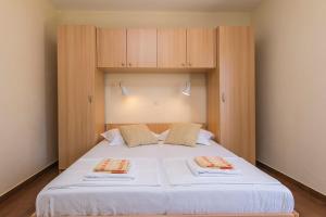 Postel nebo postele na pokoji v ubytování Apartments & Rooms Beus