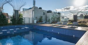 a swimming pool on the roof of a building at Top Rentals Belgrano in Buenos Aires