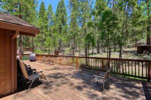 a deck with chairs and a fence and trees at 69 Bordentown West in Wawona