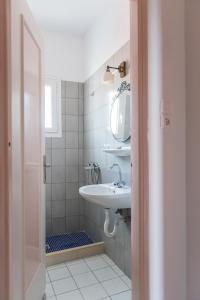 a bathroom with a sink, toilet, and bathtub at Sea View in Loutraki