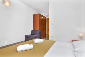 Postel nebo postele na pokoji v ubytování Apartmani Nikola