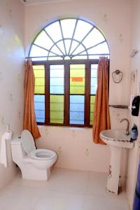 a bathroom with a toilet and a sink and a window at Kasera Heritage View in Būndi