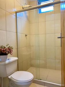 a bathroom with a toilet and a glass shower at HMG - Praia de Botafogo in Rio de Janeiro