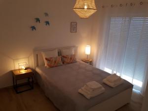 a bedroom with a bed with two towels on it at Ocean View Apartments in Portimão