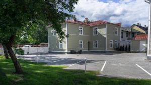 a large house with a parking lot in front of it at Kalamehe Apartment 4 near City center in Pärnu