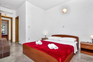 Postel nebo postele na pokoji v ubytování Apartmani Nikola