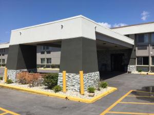 an empty parking lot in front of a building at Super 8 by Wyndham South Holland in South Holland