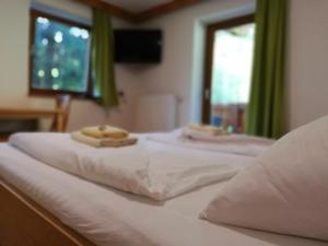 a white bed with two towels on top of it at Hotel Valerie in Saalbach Hinterglemm