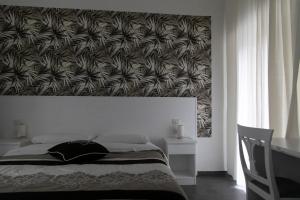 a bedroom with a bed with a large wall at B&B Alambrado Rooms & Suites in Naples