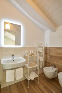 a white bathroom with a sink and a mirror at Agriturismo Casastella in Ceriale