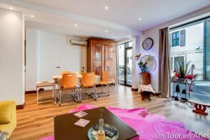 a living room with a table and chairs at Un tour en Arles in Arles