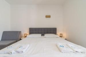 Posteľ alebo postele v izbe v ubytovaní Apartments Coronata