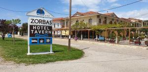 a hotel tavern sign on the side of a street at Zorbas Hotel in Myrtéa