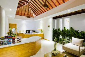 an office with a reception desk and a couch at Chi Samui Resort in Bophut