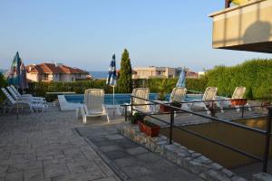 a group of chairs sitting next to a swimming pool at Villa Vega in Sozopol