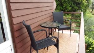 two chairs and a table on a patio at Chalé da Fonte - T2 in Geres