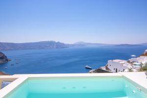 a view of the ocean from the balcony of a house at Aloia Villas in Oia