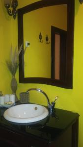 a bathroom with a sink with a mirror and a sink at Sole Apartments in Kotor