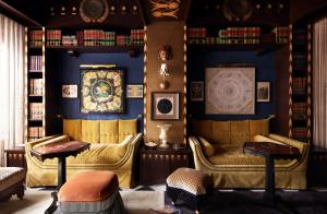 a living room filled with furniture and a clock at Maison de la Luz in New Orleans