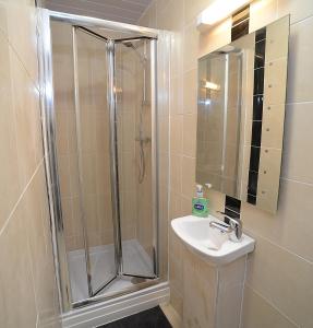 a bathroom with a shower and a sink at The Winter Garden Suites in Blackpool