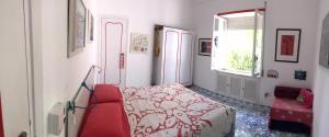 a living room with a red couch and a window at Casa Lucky - Anacapri in Anacapri